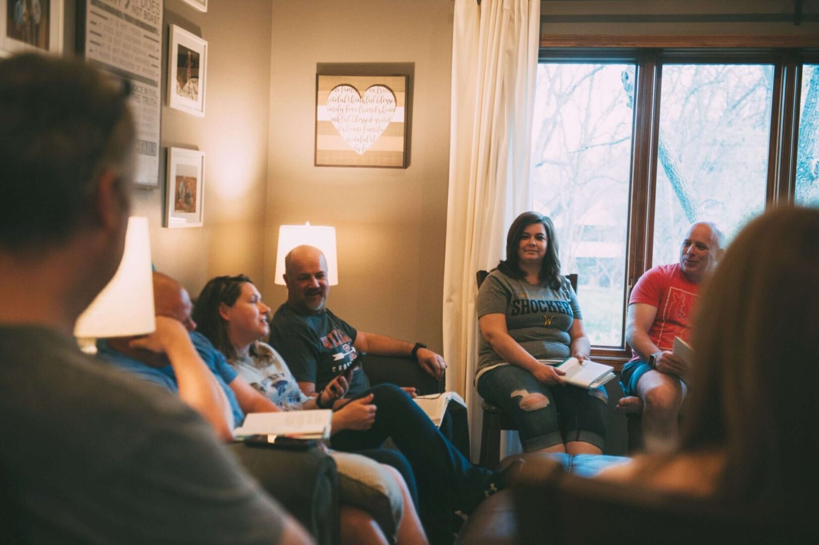 A group of people sitting in chairs and talking.