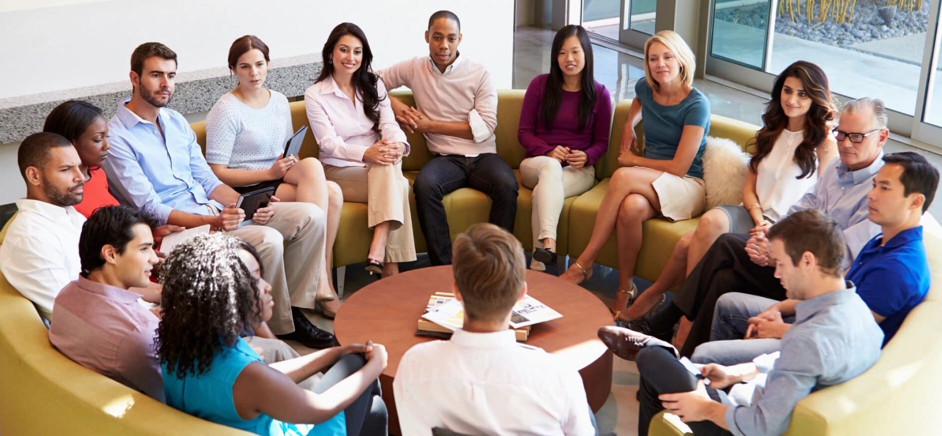 A group of people sitting around each other in a circle.